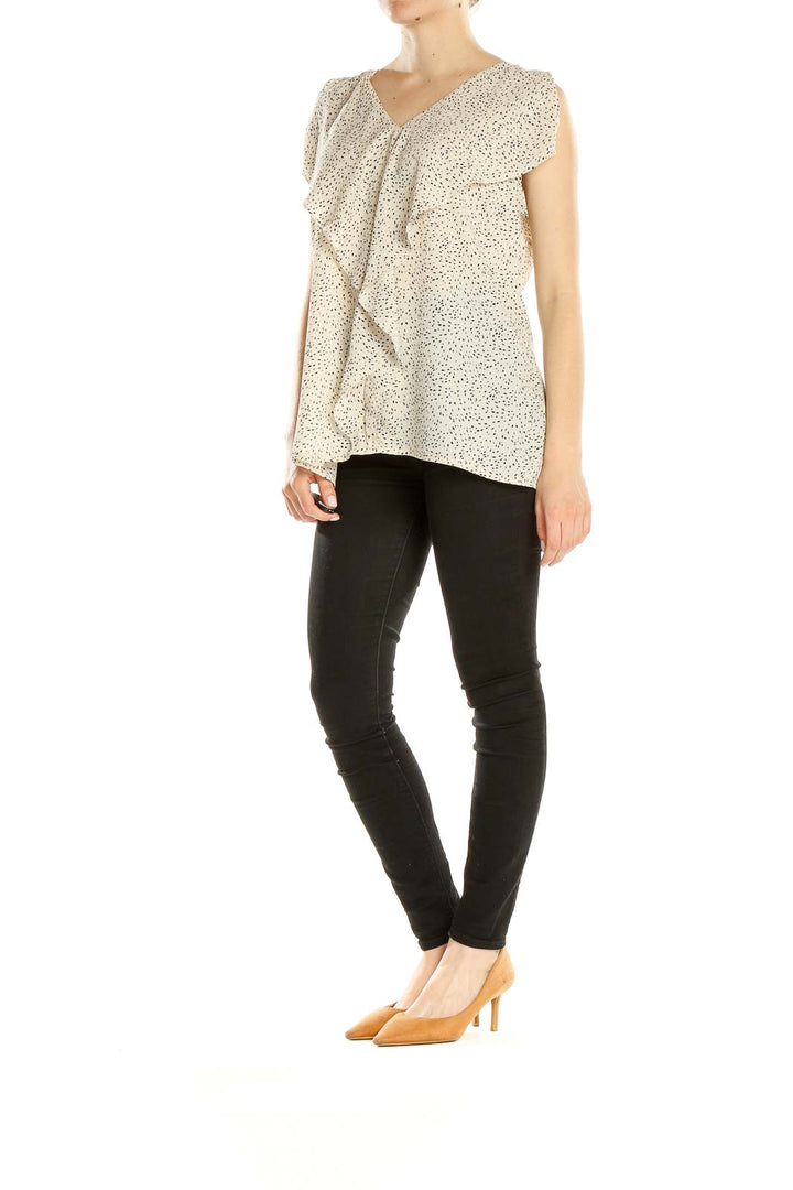 Front view of cream speckled IMNYC Isaac Mizrahi blouse with ruffle detail