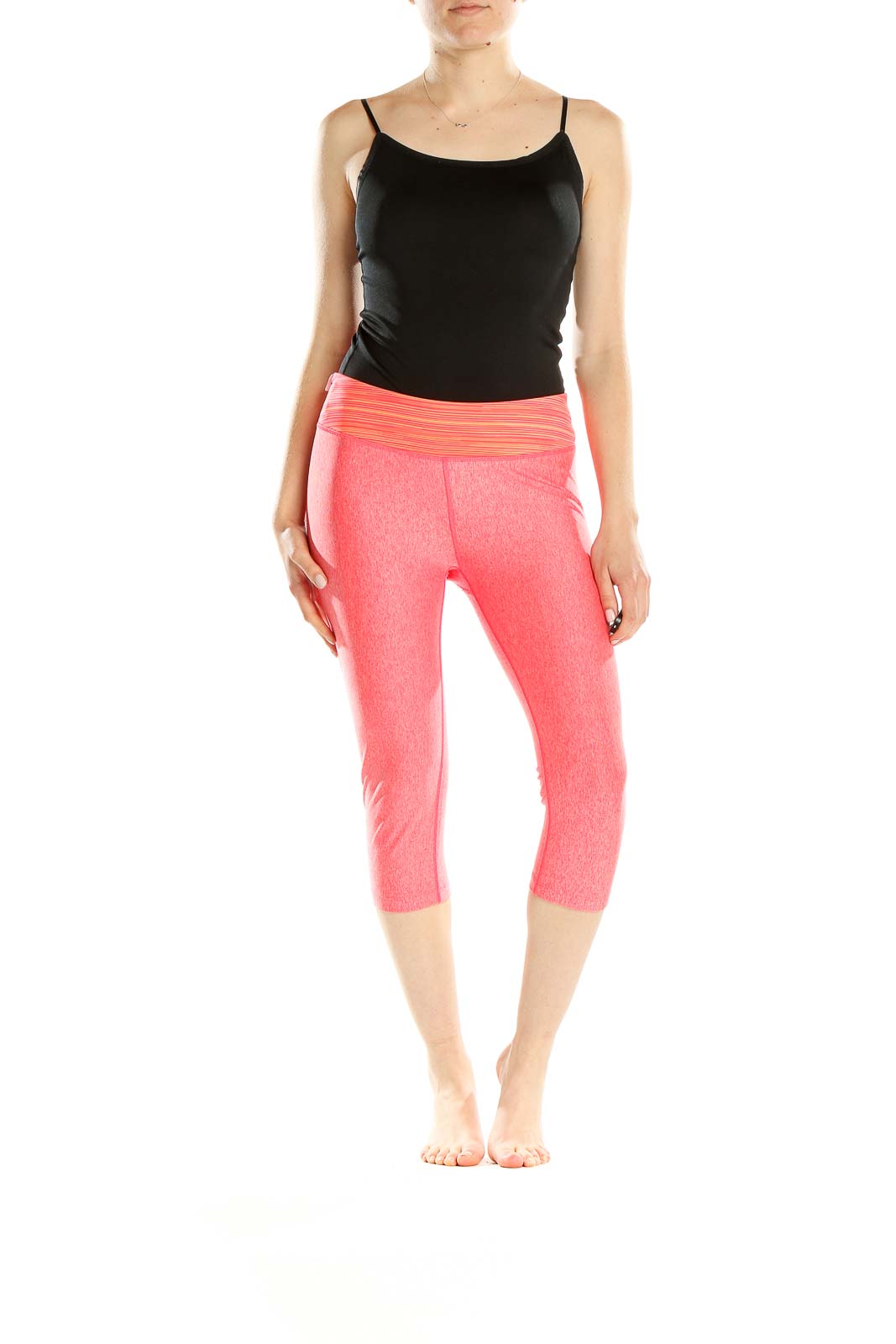 Front view of pink Under Armour capri workout leggings on model