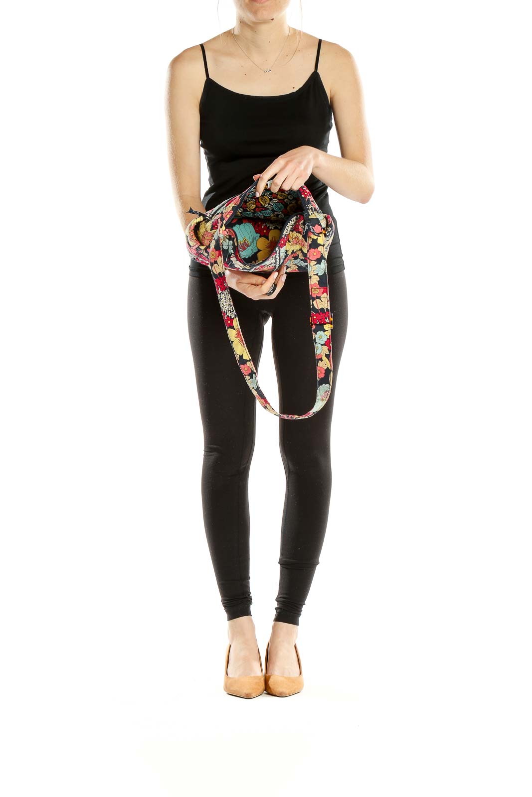 Side view of person wearing Vera Bradley multicolor floral quilted shoulder bag