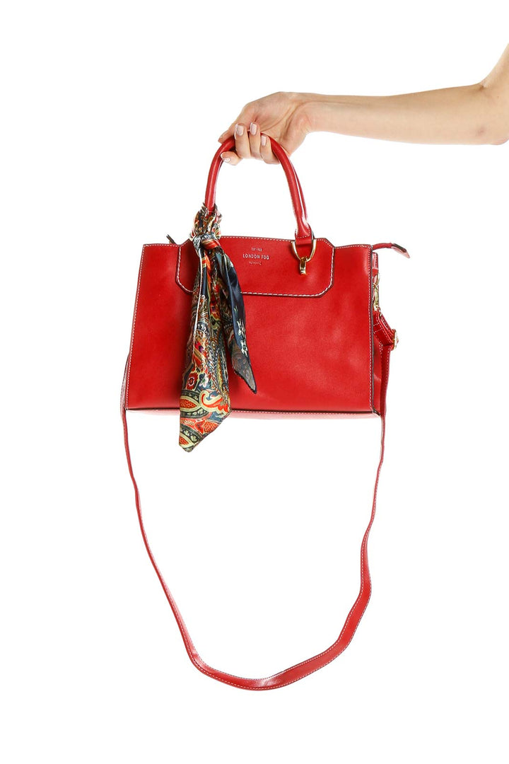Front view of red leather London Fog crossbody bag with colorful scarf accent