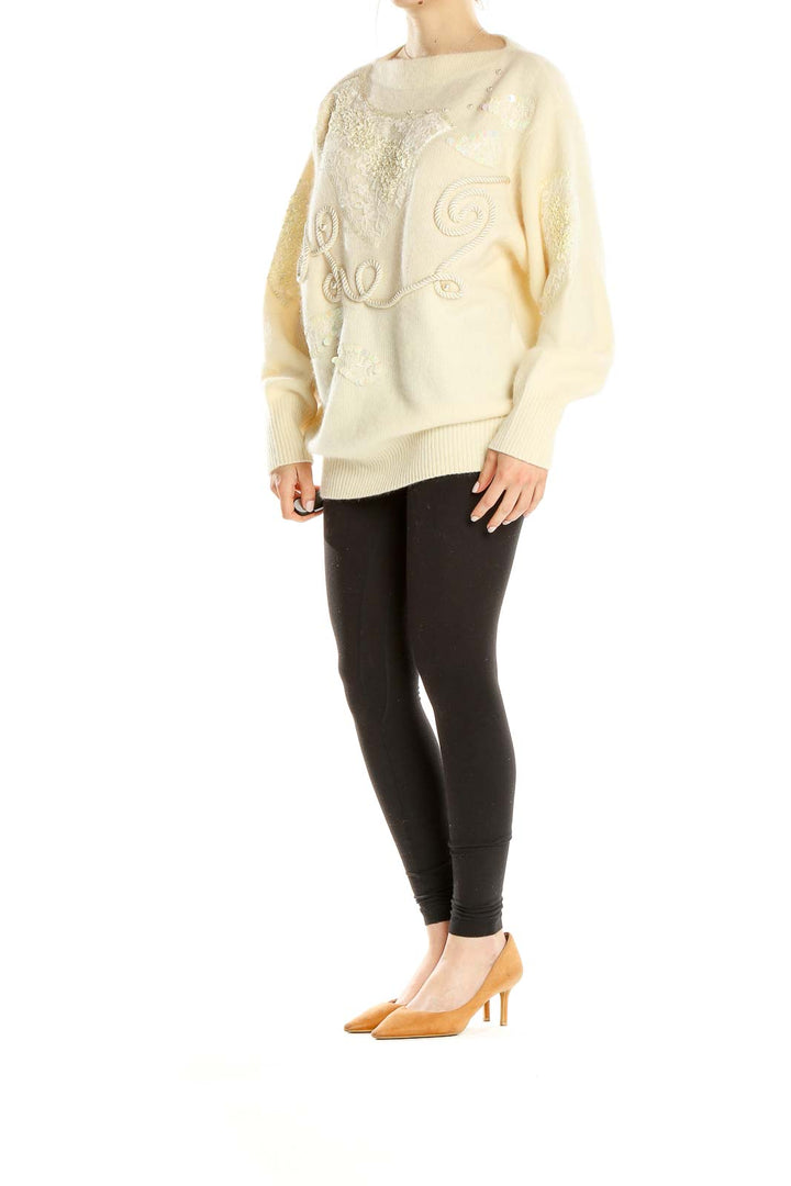 Front view of cream Apart oversized knit sweater with sequin embellishments and rope embroidery