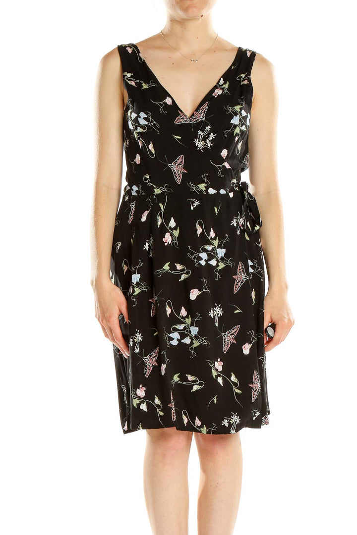 Front view of Field Day black sleeveless dress with floral and butterfly print