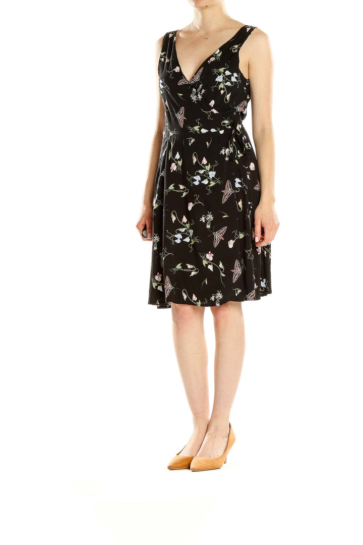 Front view of Field Day black sleeveless dress with floral and butterfly print
