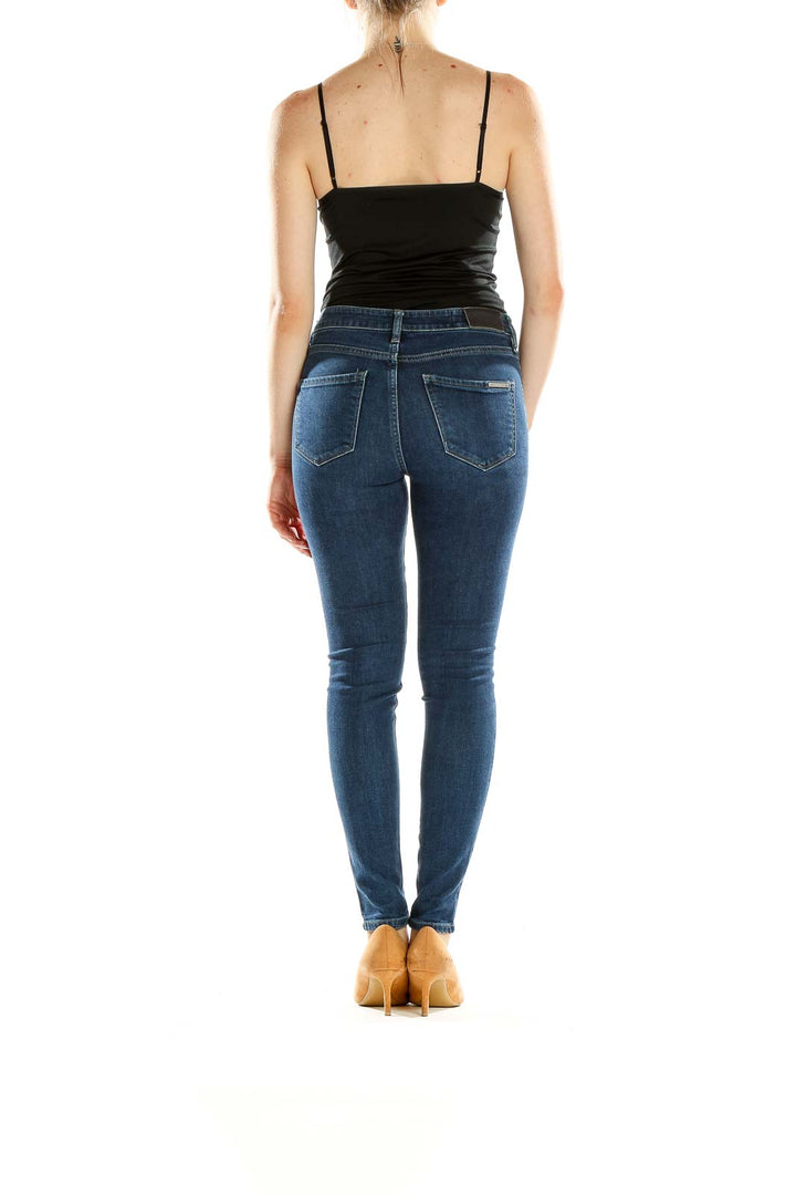Side view of Armani Exchange blue skinny jeans on model