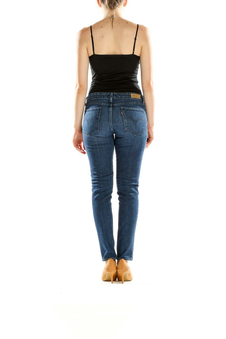 Side view of Levi's classic blue straight leg jeans on model
