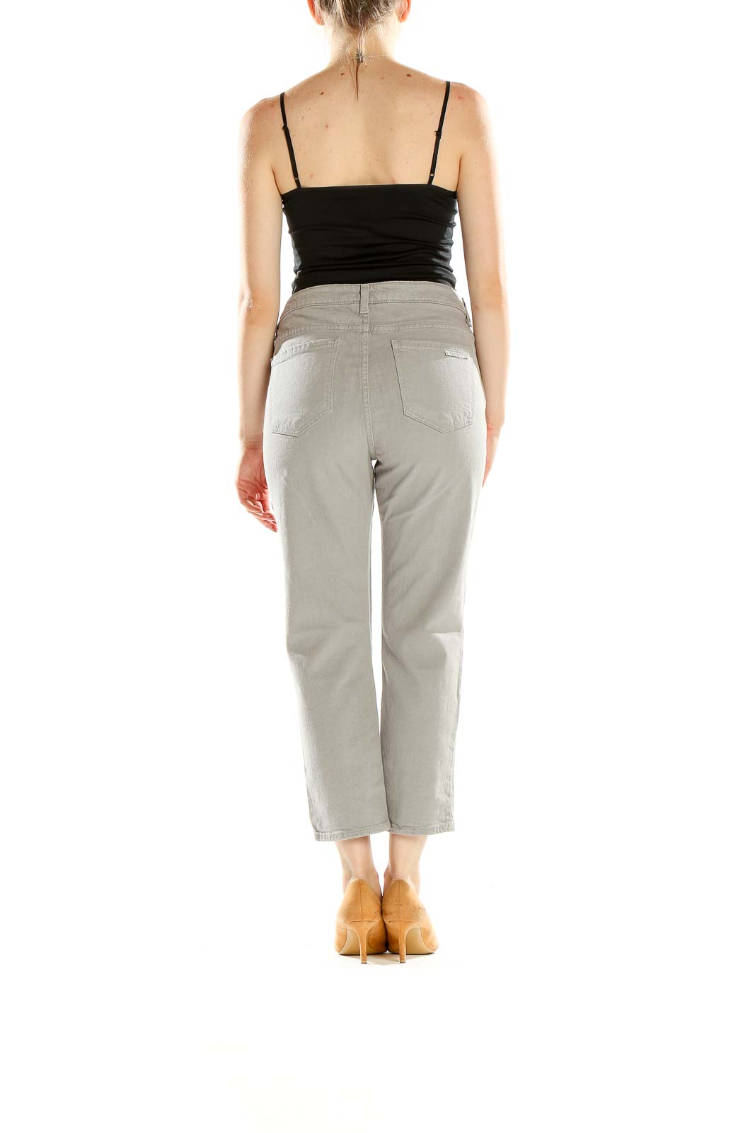 Side view of model wearing MICHAEL Michael Kors light gray cropped denim jeans