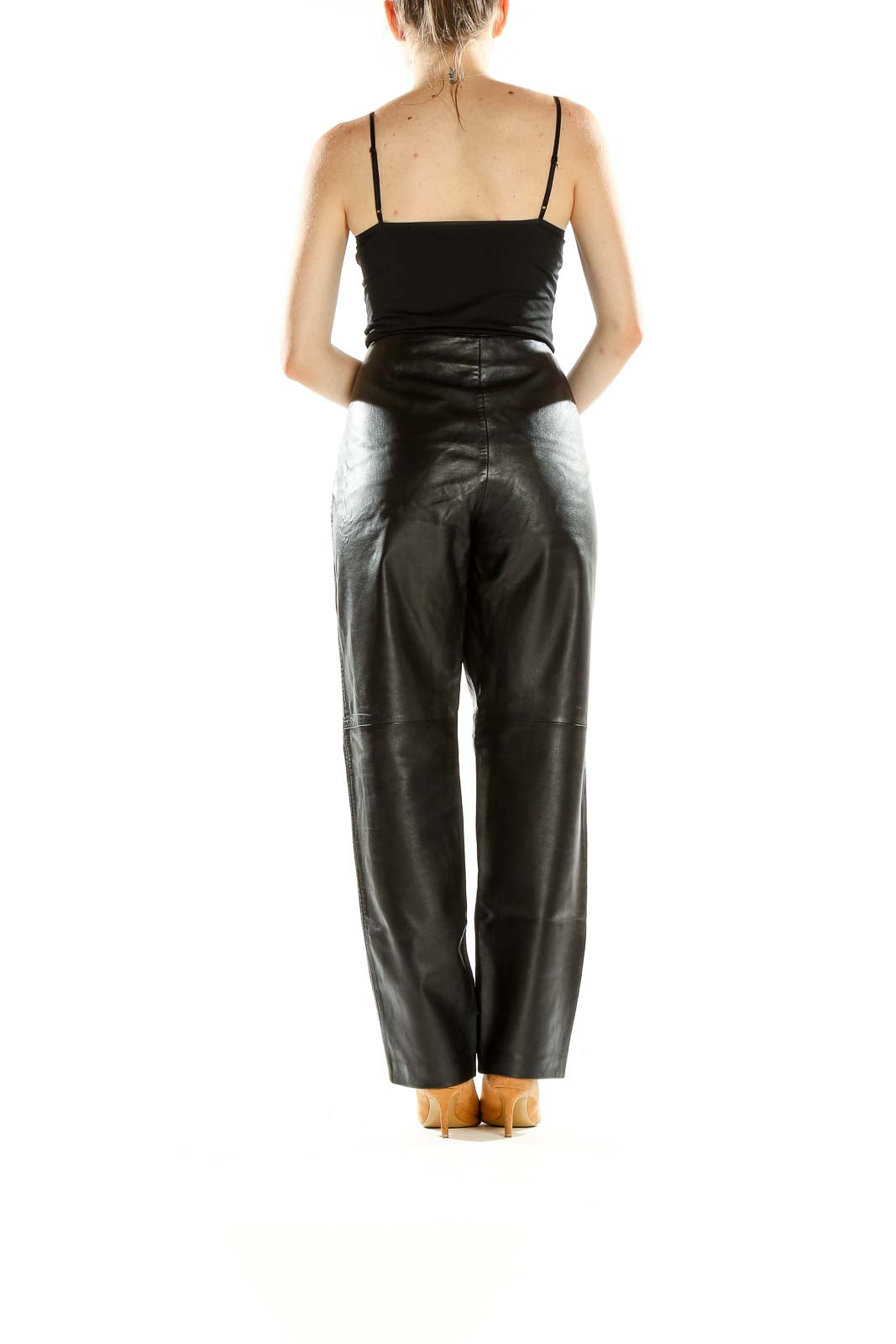 Side view of Hugo Buscati black leather wide-leg trousers paired with black top