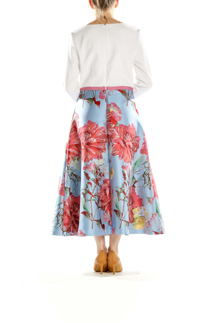 Side view of Theia blue floral metallic midi dress showing flared skirt and long white sleeves