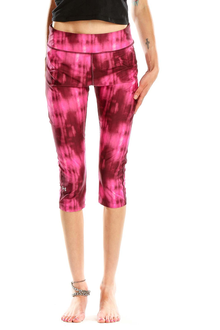 Front view of pink tie-dye Under Armour capri leggings
