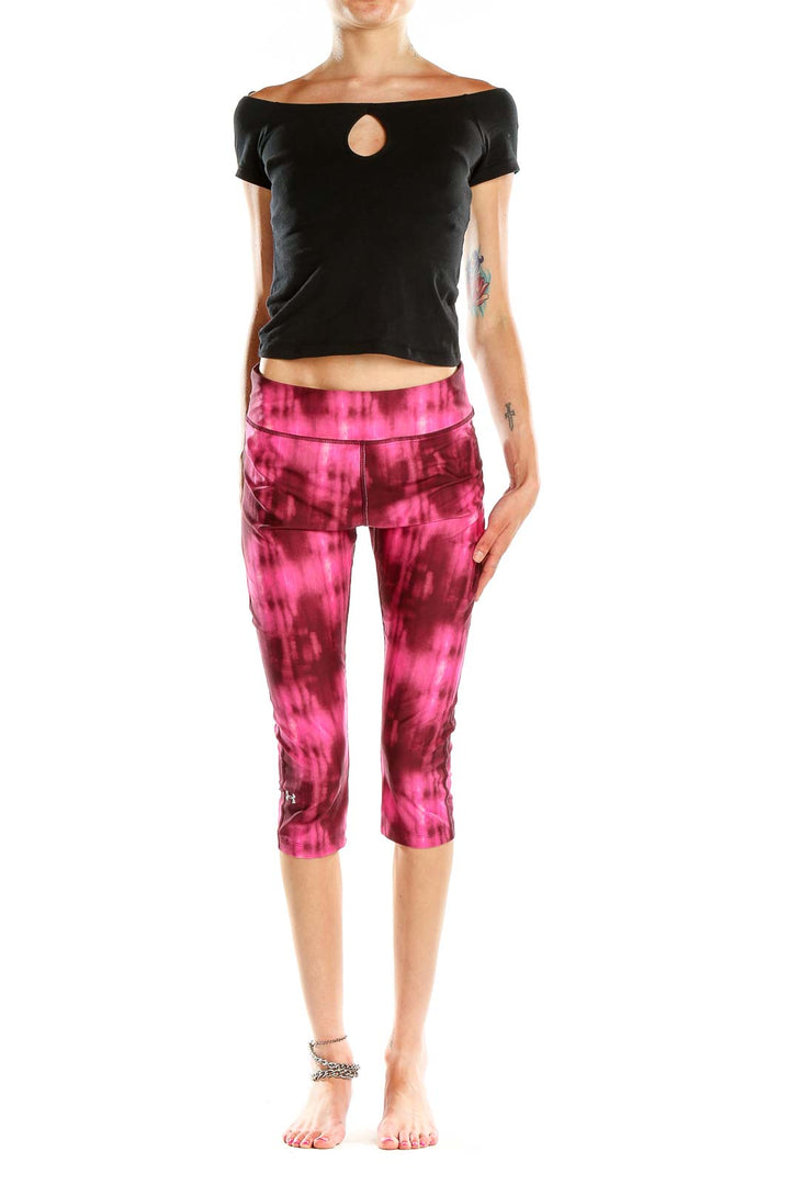 Front view of pink tie-dye Under Armour capri leggings