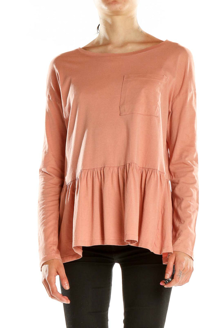 Front view of peach long-sleeve peplum top by For the Republic
