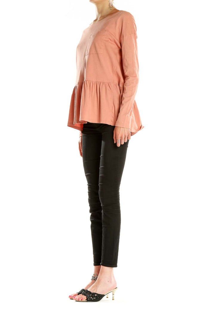 Front view of peach long-sleeve peplum top by For the Republic