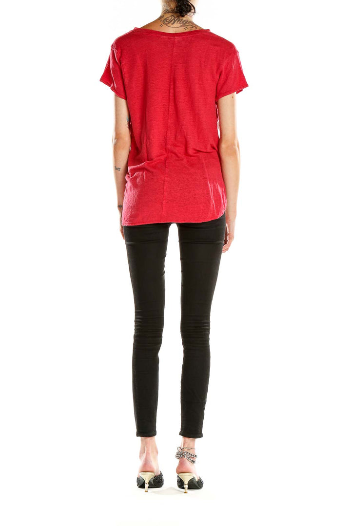 Side view of red Tahari V-neck T-shirt on model with black pants