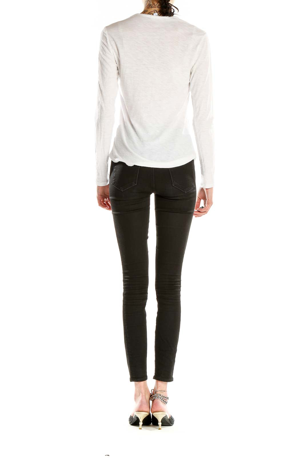 Side view of white long-sleeve top by Standard James Perse on model