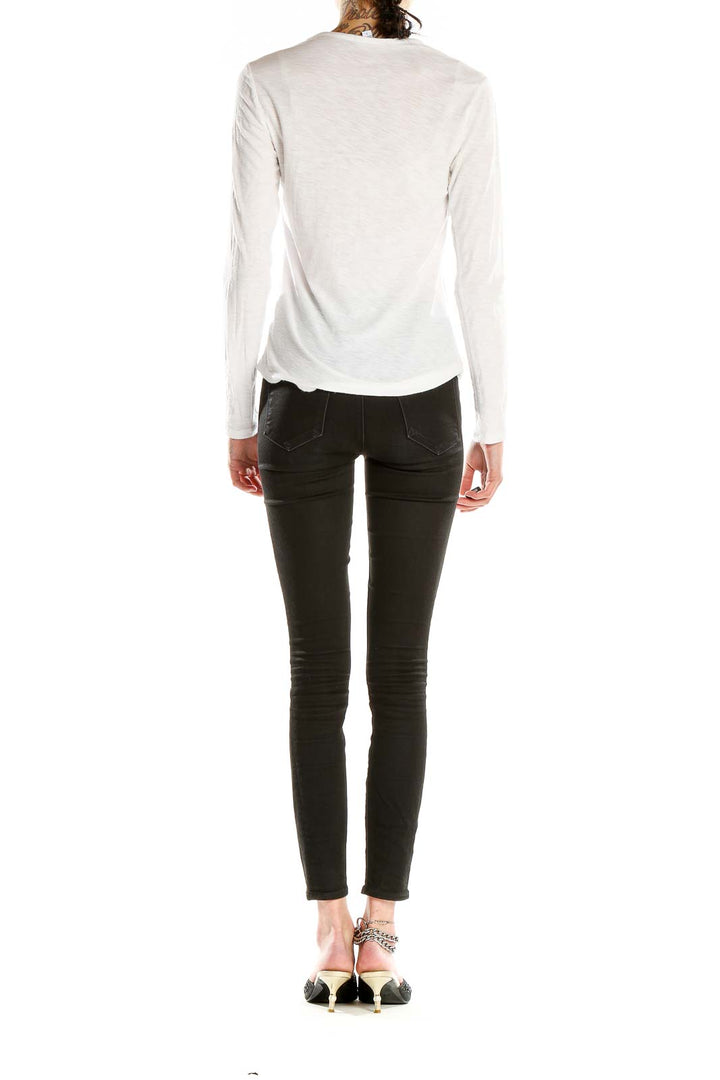 Side view of white long-sleeve top by Standard James Perse on model