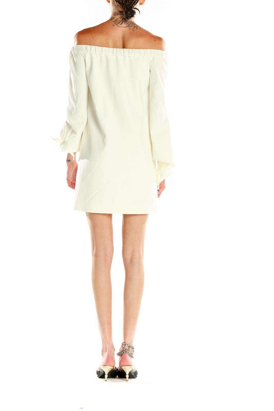 Side view of Tibi ivory off-shoulder mini dress showing bell sleeves
