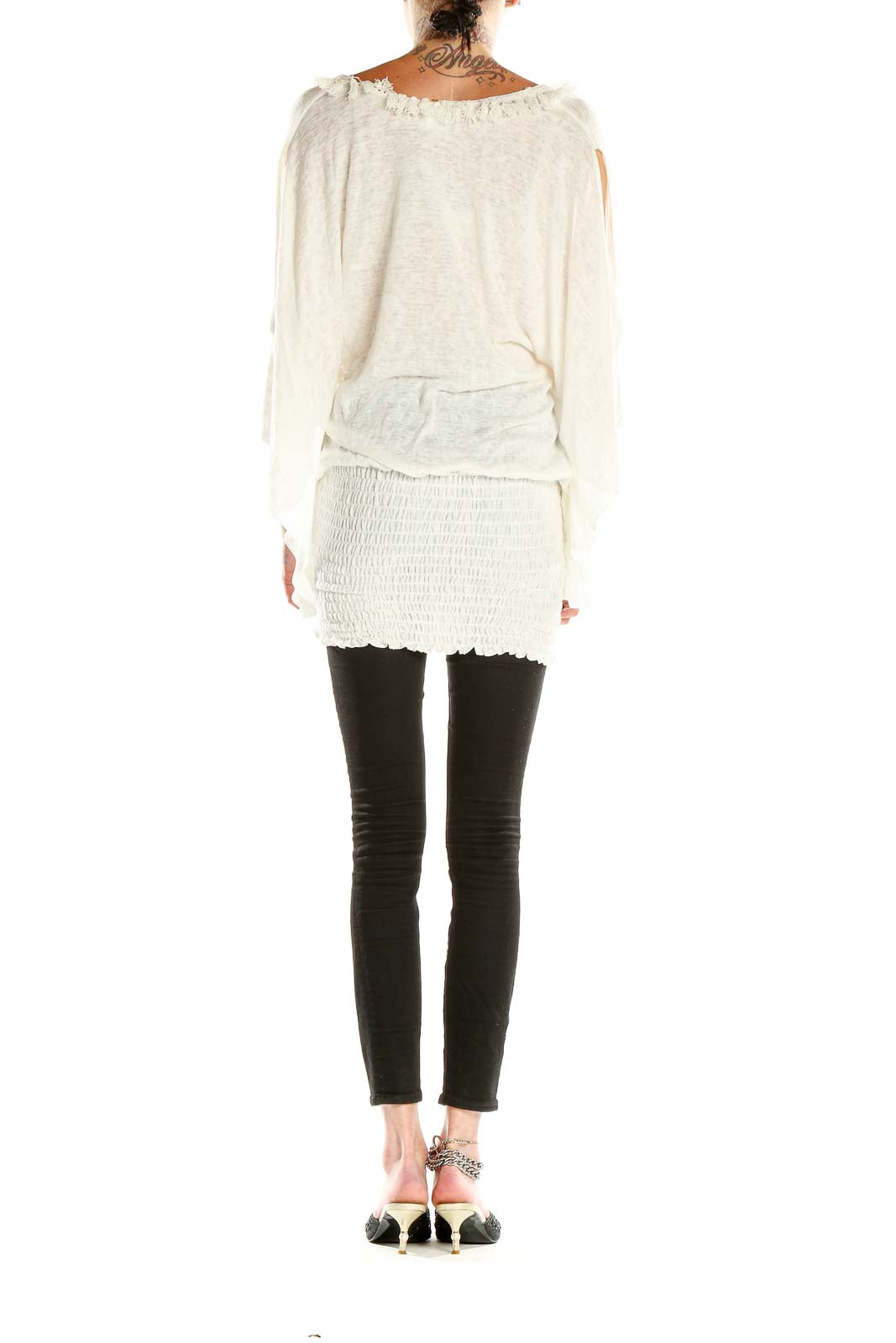 Side view of white tunic top showing smocked waistband and flowy silhouette