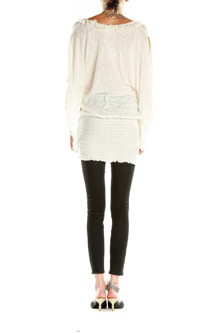 Side view of white tunic top showing smocked waistband and flowy silhouette