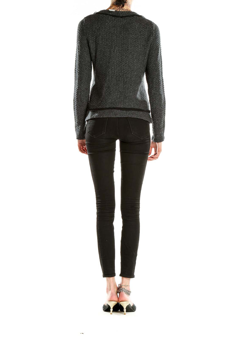 Side view of woman wearing Banana Republic gray textured knit cardigan jacket with black pants