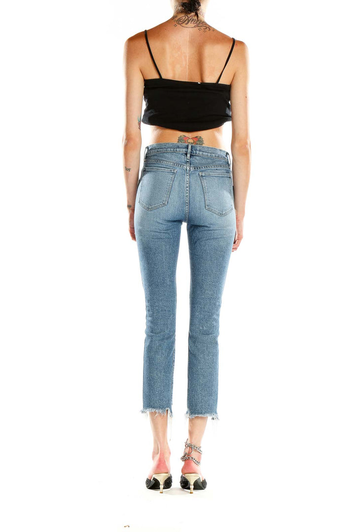 Side view of 3x1 Denim light blue cropped flare jeans on model