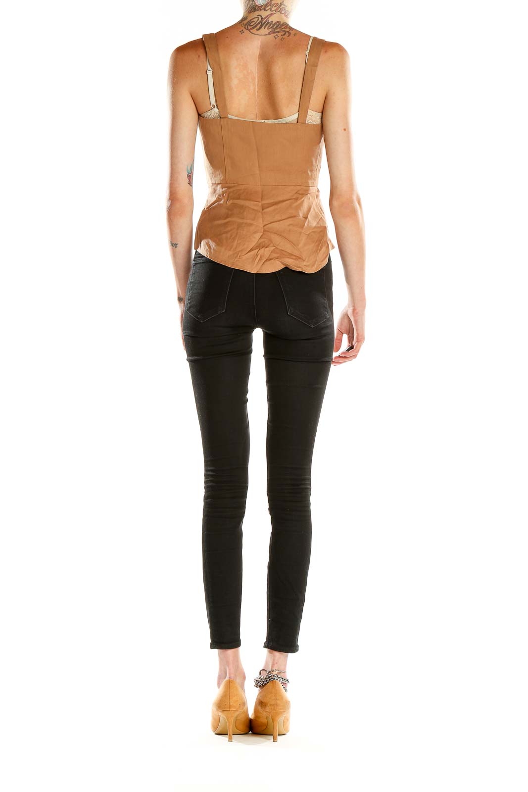 Side view of model wearing BCBG MaxAzria camel button-front sleeveless crop top with black pants