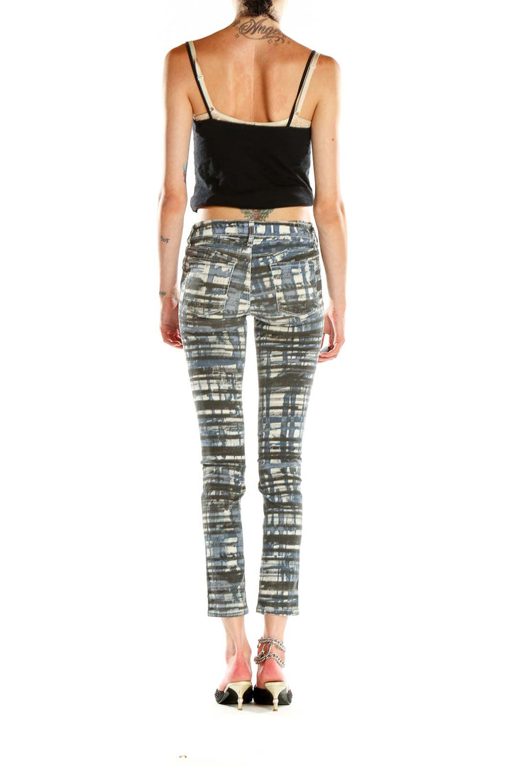 Side view of model wearing David Kahn blue and gray striped skinny jeans