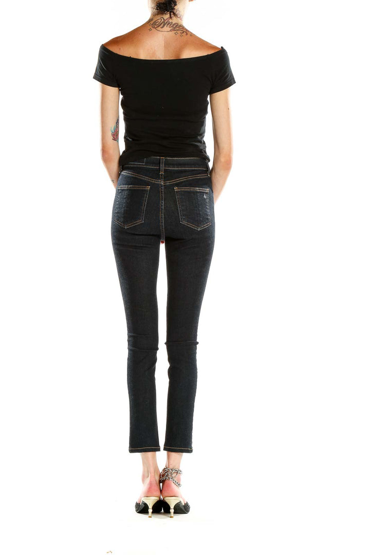Side view of woman wearing Rag & Bone dark blue slim fit cropped jeans