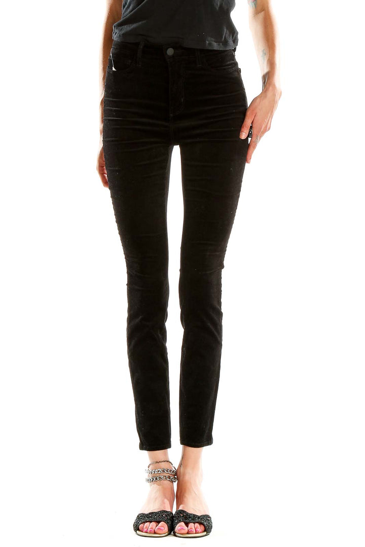 Front view of L'AGENCE black velvet high-waisted skinny pants on model