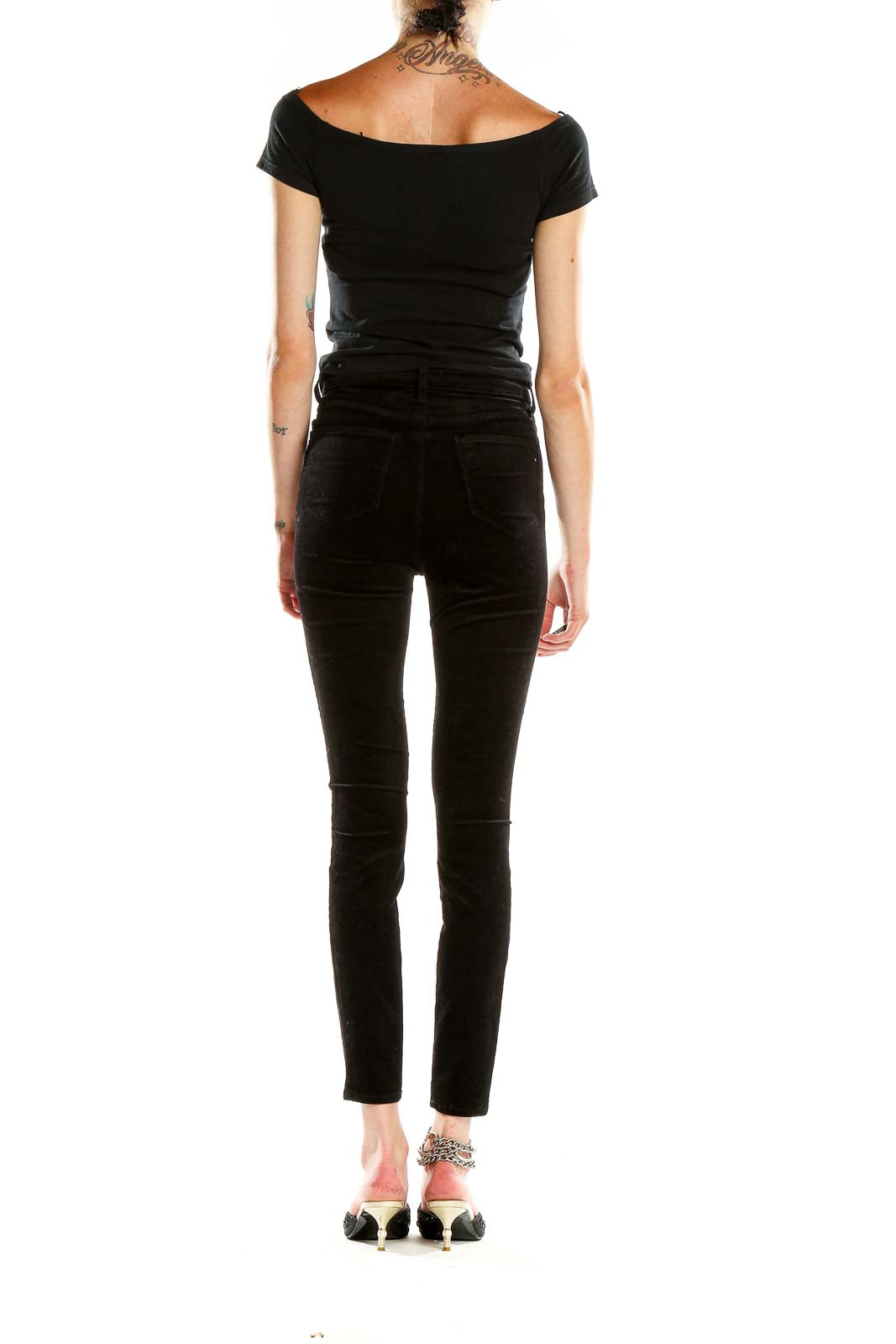 Side view of L'AGENCE black velvet high-waisted skinny pants on model