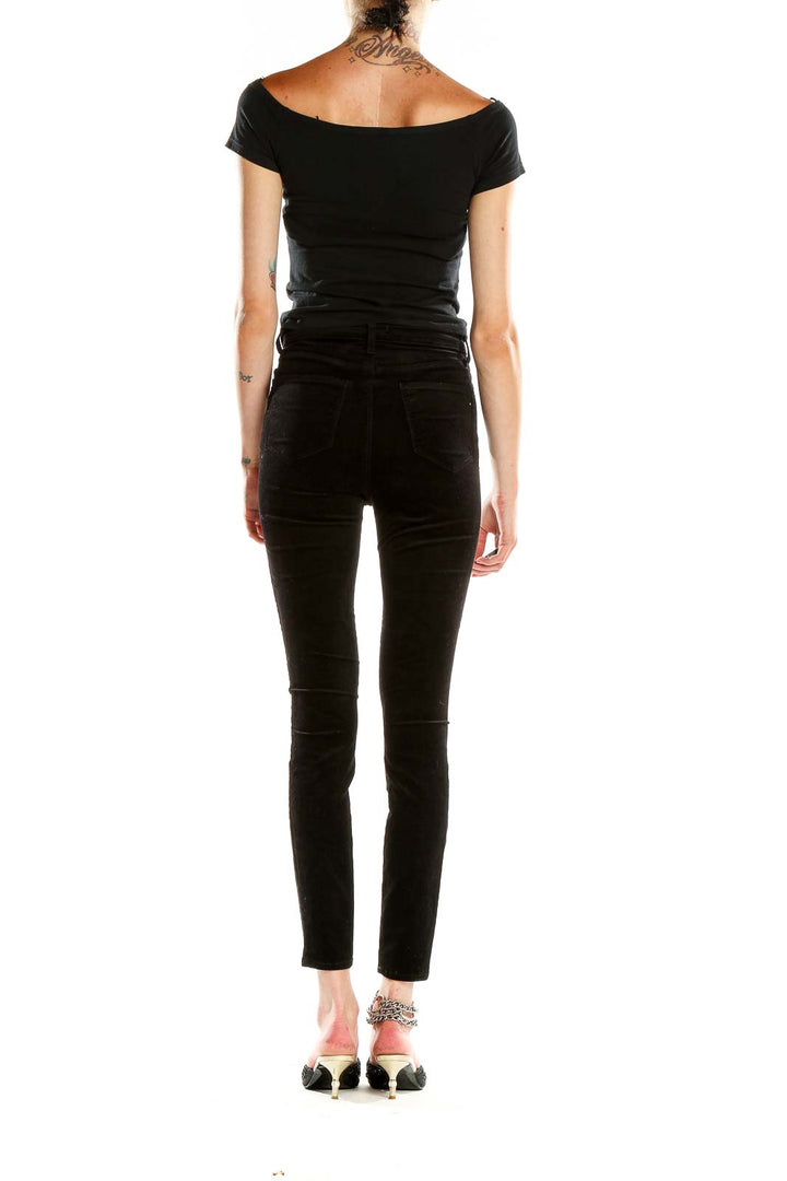 Side view of L'AGENCE black velvet high-waisted skinny pants on model