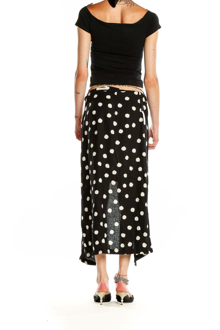 Side view of Urban Outfitters Black and White Polka Dot Maxi Skirt showing waistband and length