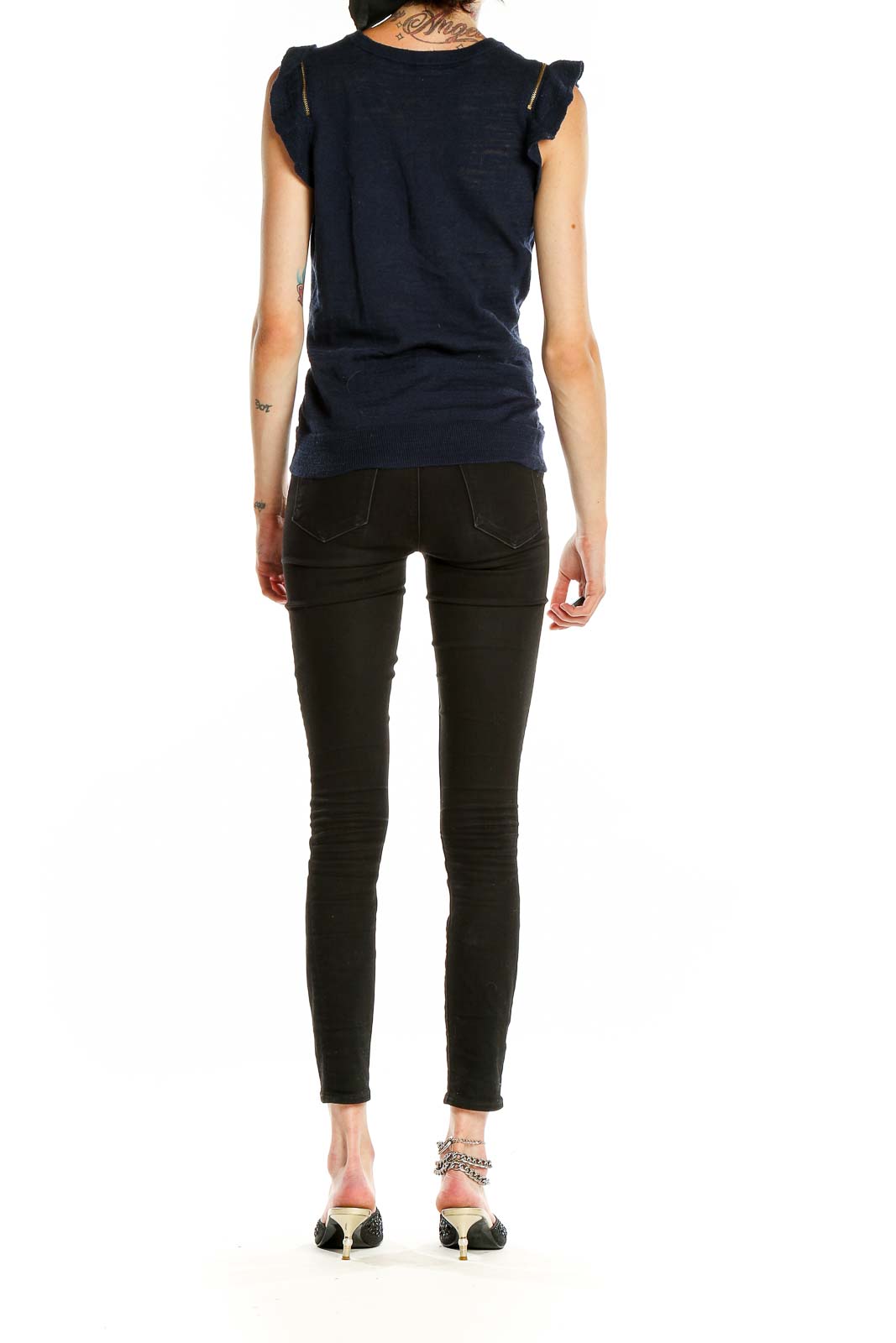 Side view of MICHAEL Michael Kors navy sleeveless knit top showing ruffled shoulder detail