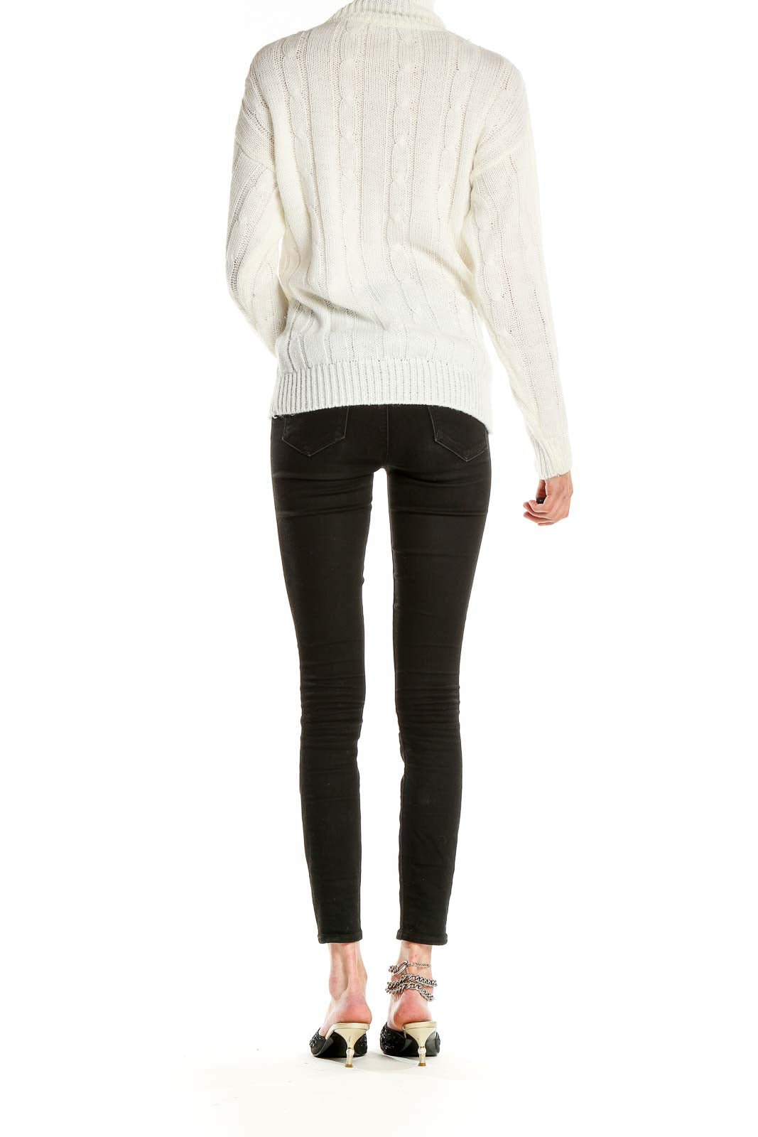 Side view of Nan Dorsey cream cable knit turtleneck sweater on model
