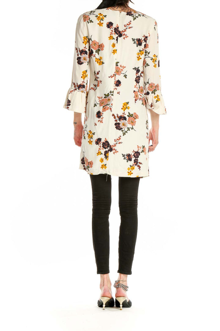 Back view of Sanctuary cream floral mini dress showing all-over print