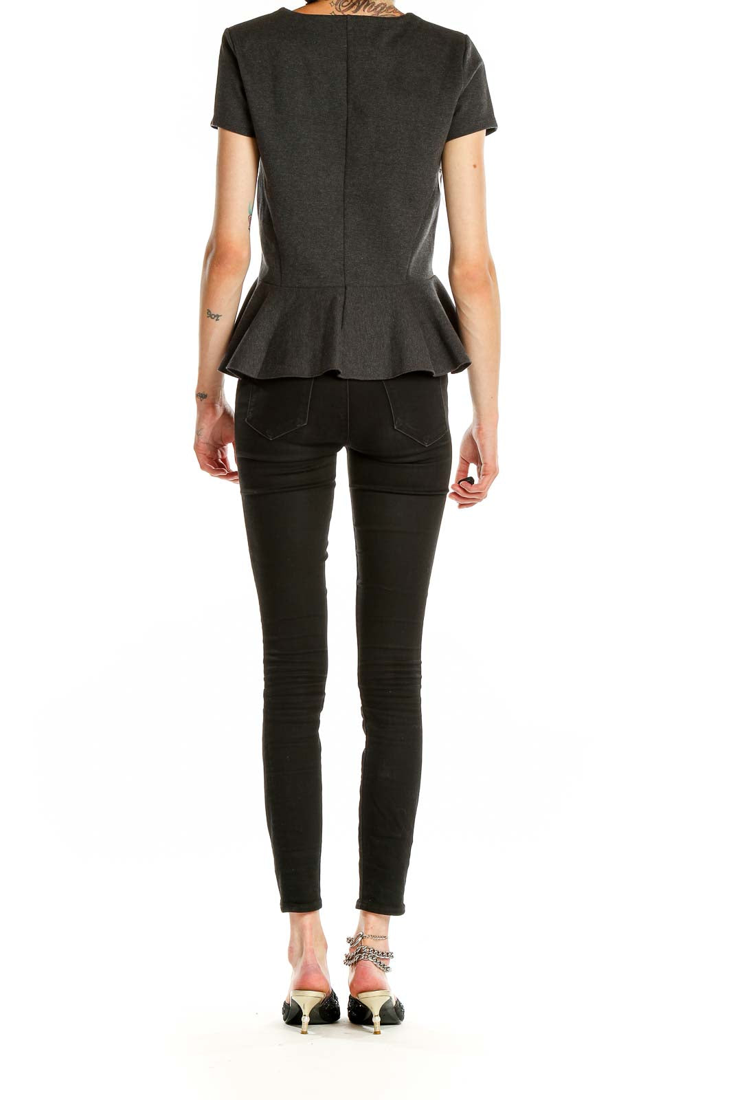 Side view of J.Crew charcoal peplum short sleeve top on model
