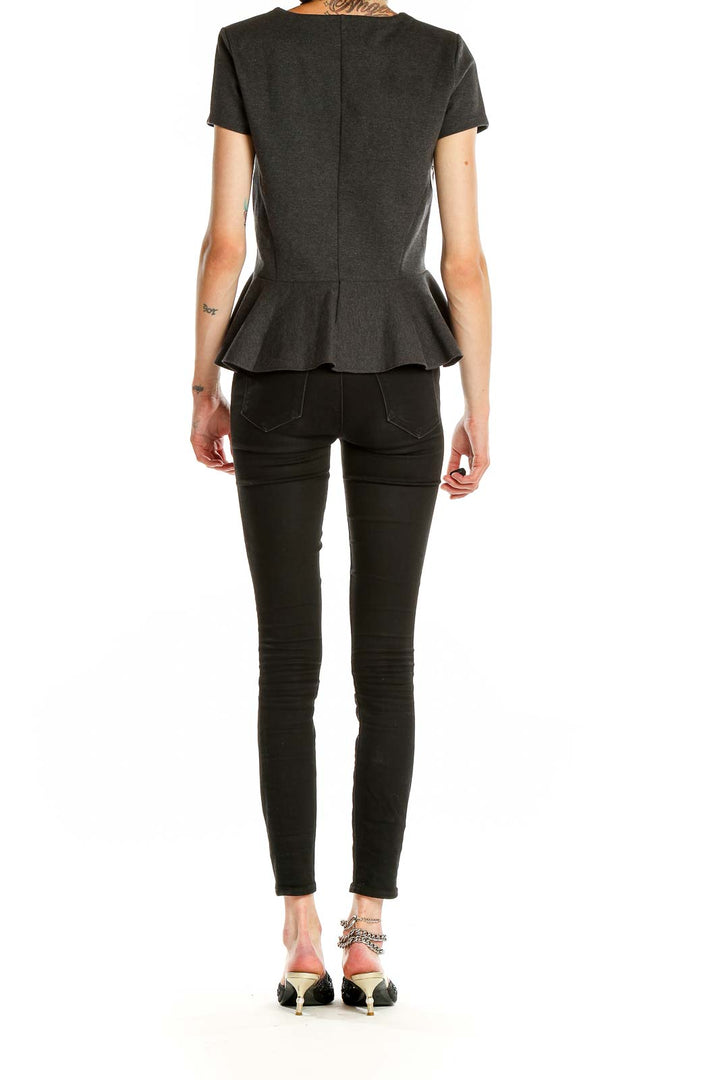 Side view of J.Crew charcoal peplum short sleeve top on model