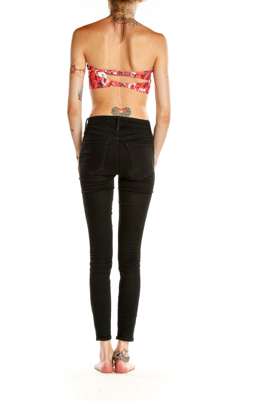 Back view of red floral strapless crop top from Free People with black jeans