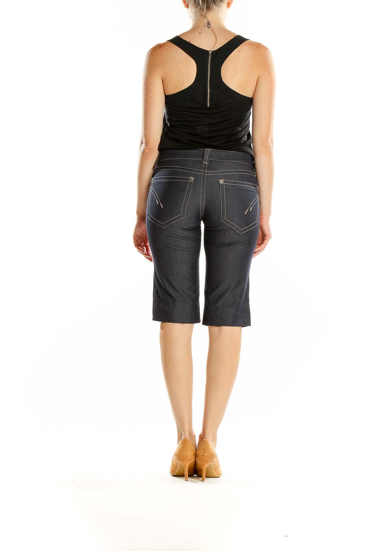 Back view of Billy Blues dark blue denim Bermuda shorts on model
