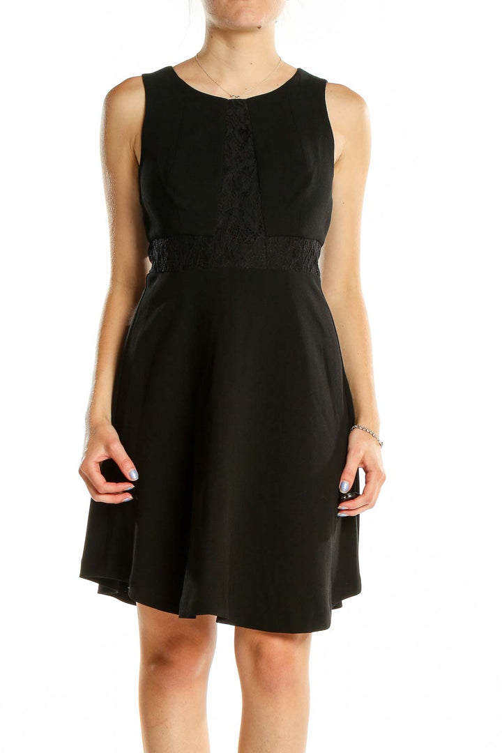 Front view of BCBGeneration black sleeveless cocktail dress with lace detail