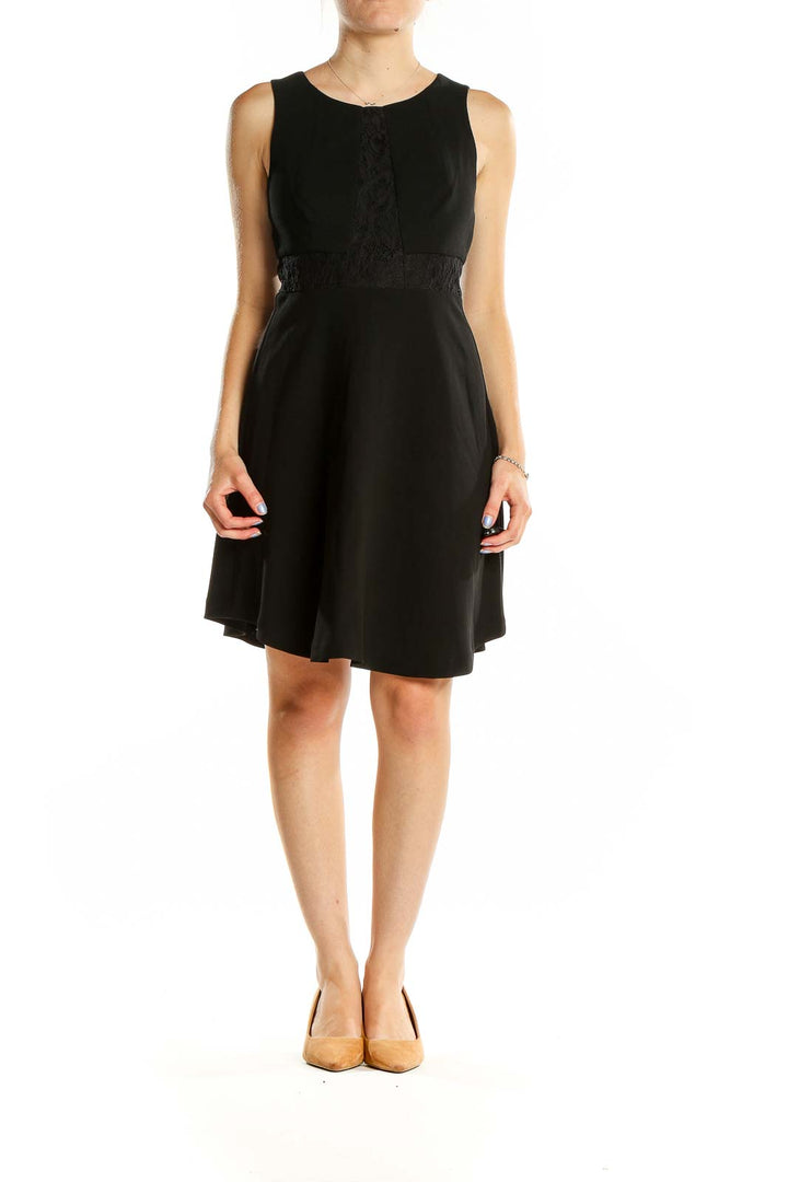 Front view of BCBGeneration black sleeveless cocktail dress with lace detail