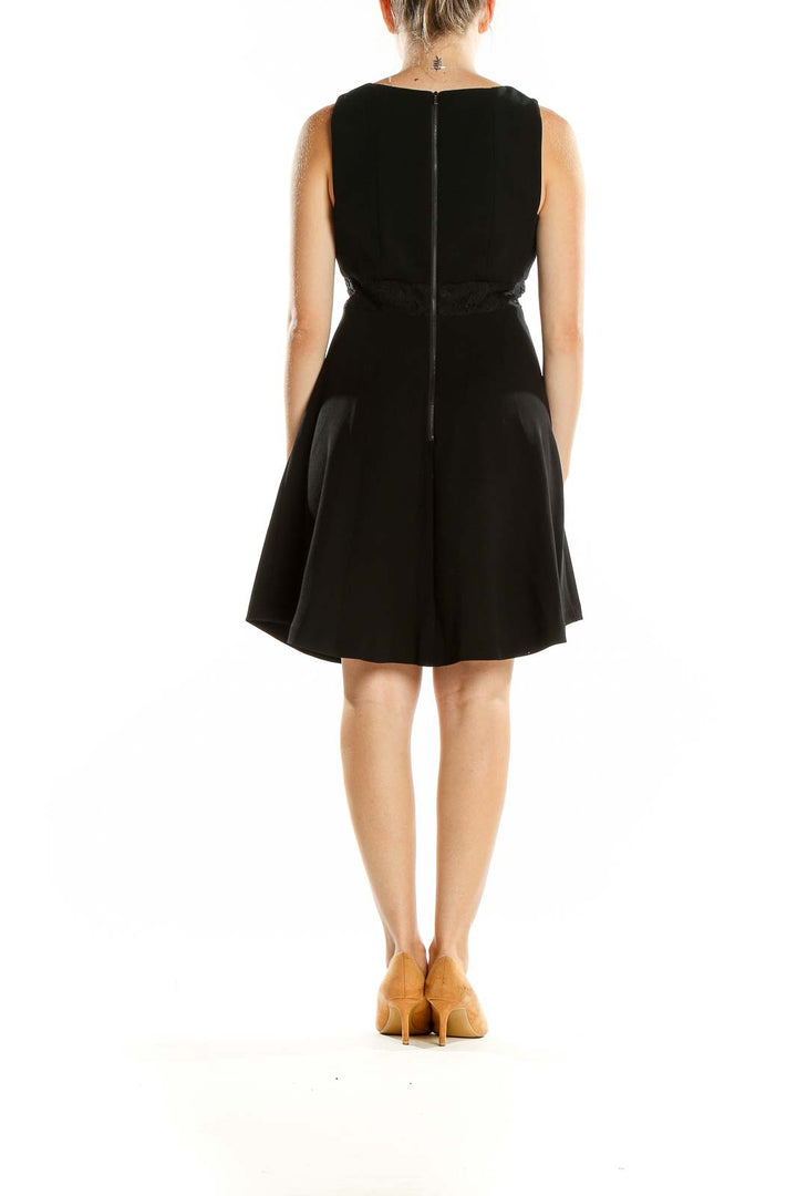 Back view of BCBGeneration black sleeveless cocktail dress showing zipper closure