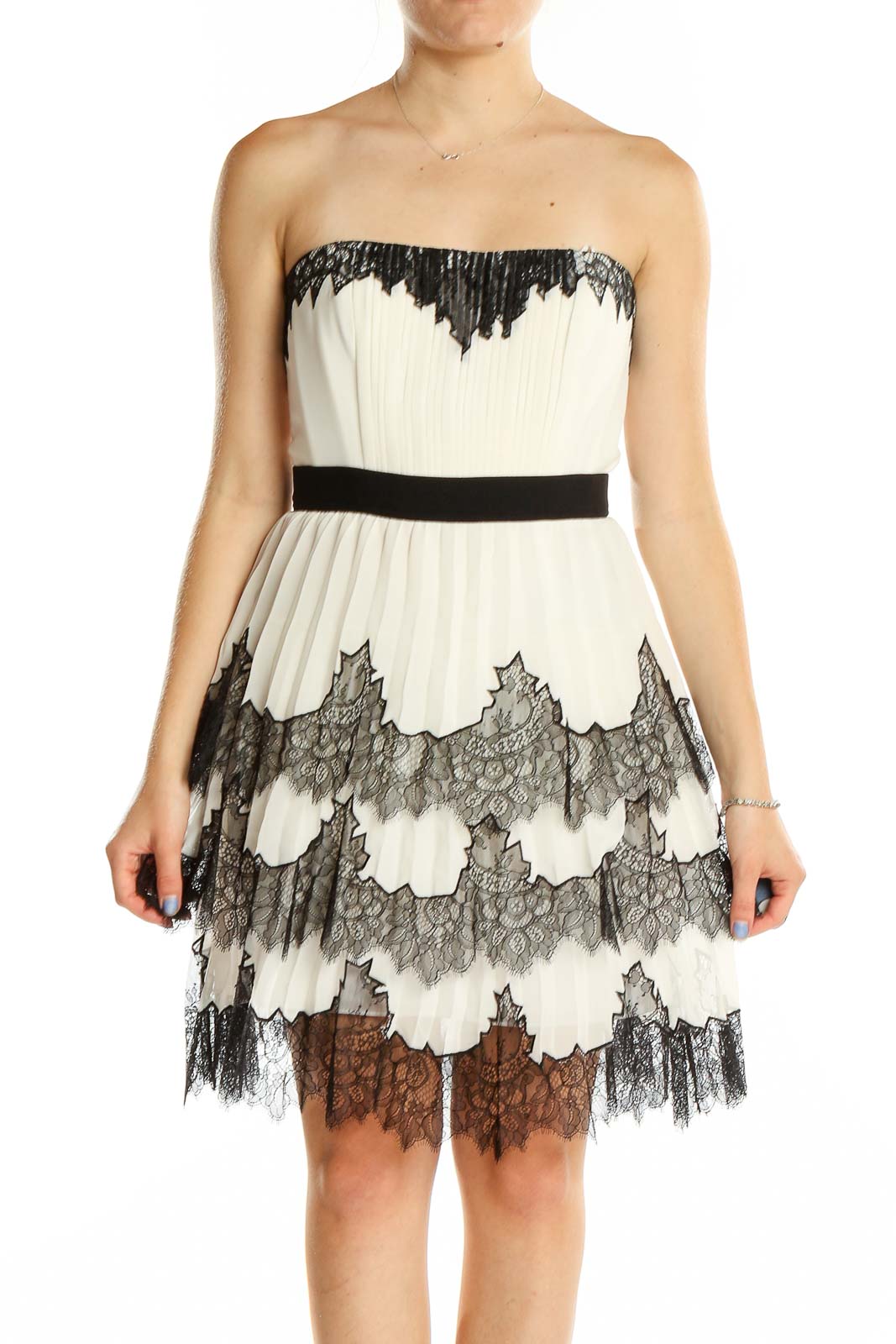 Front view of BCBG MaxAzria white lace strapless cocktail dress with black trim and tiered skirt