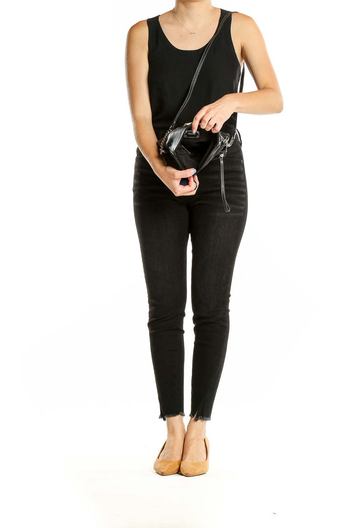 Model wearing Nine West black leather crossbody bag with casual outfit