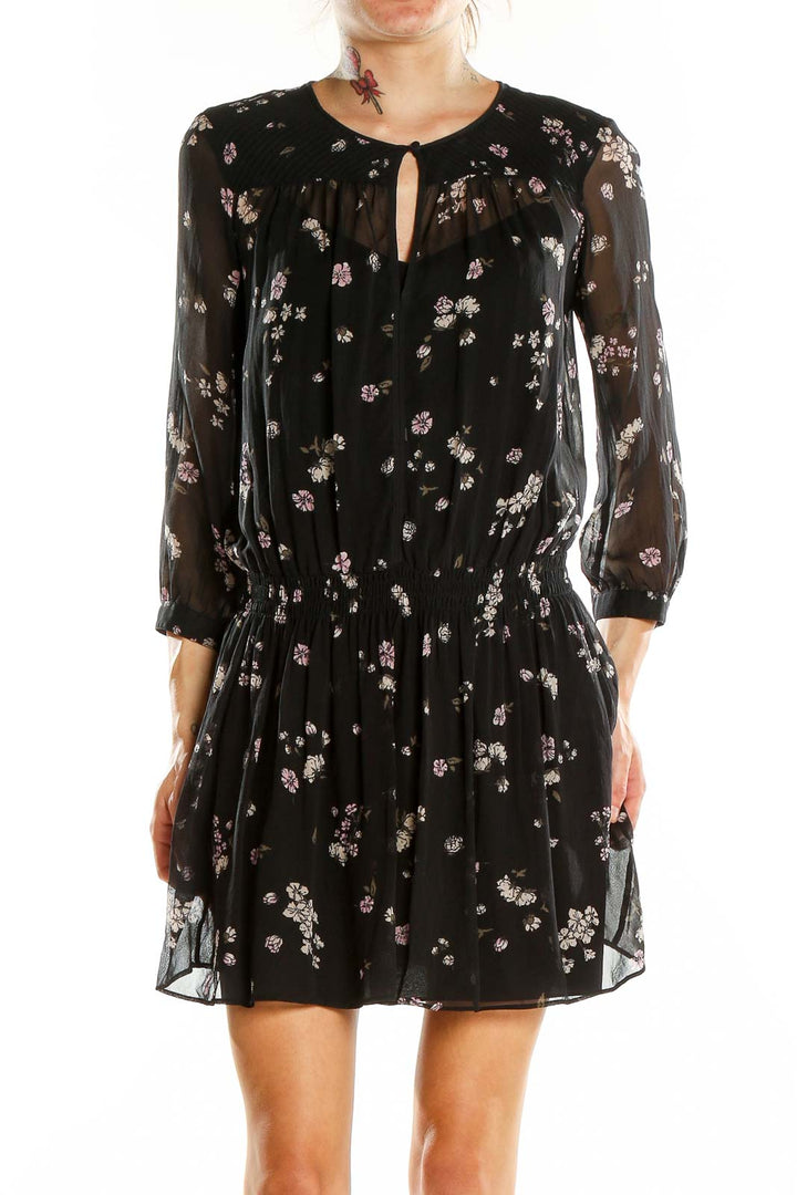 Front view of Club Monaco black floral sheer mini dress with keyhole neckline