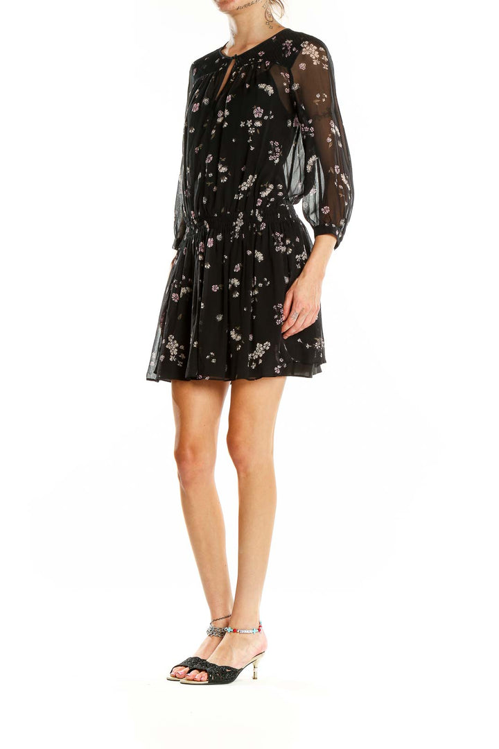 Front view of Club Monaco black floral sheer mini dress with keyhole neckline