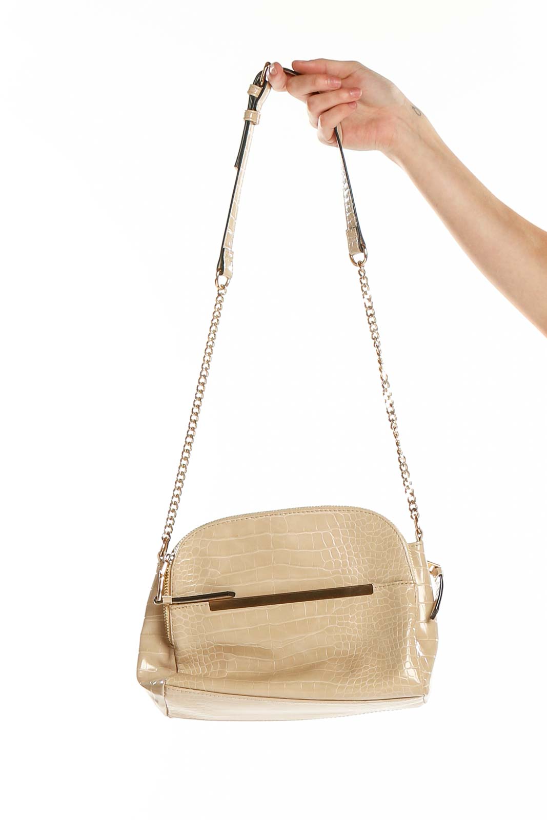 Front view of beige croc-embossed crossbody bag with gold-tone accent