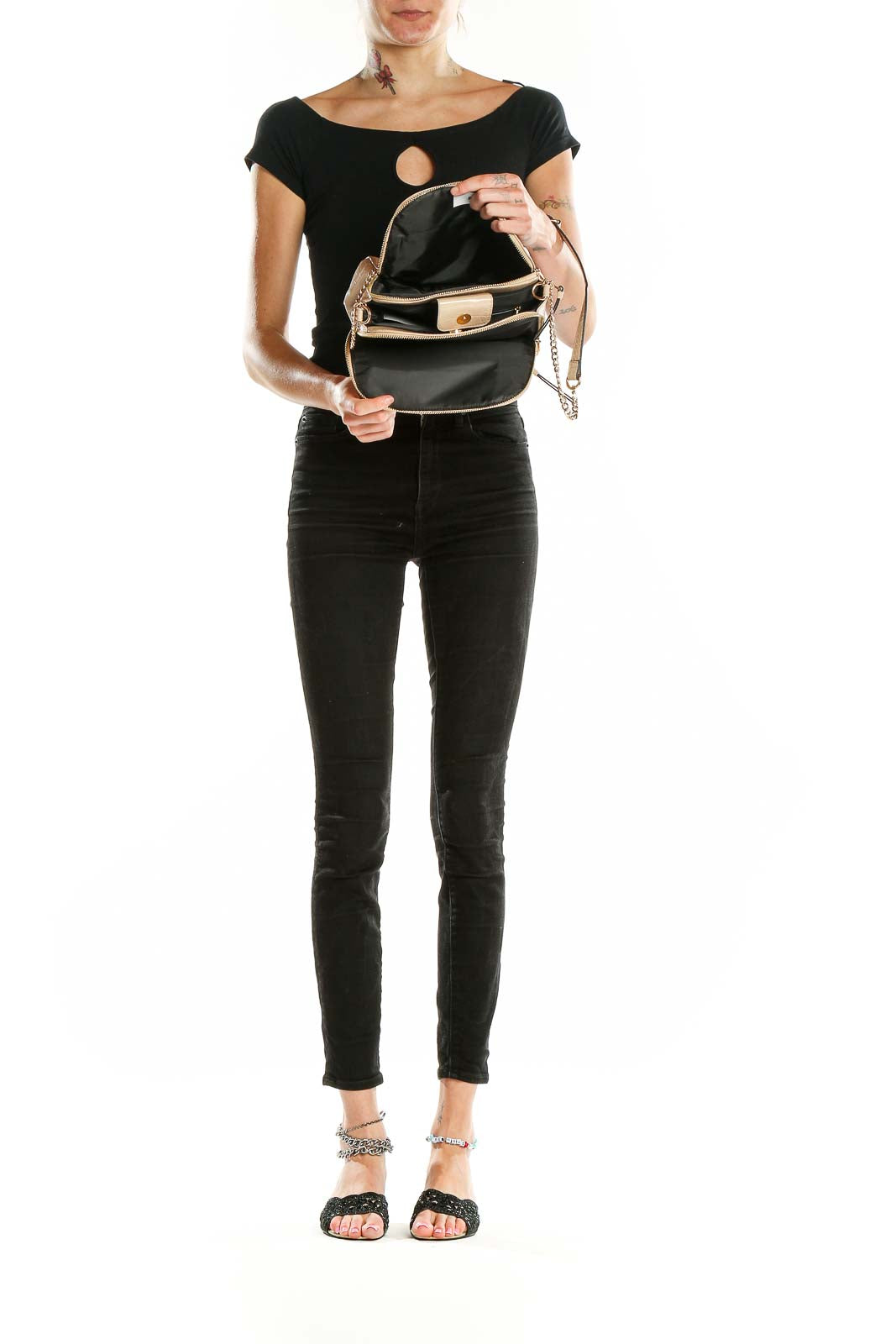 Model wearing beige croc-embossed crossbody bag with black outfit