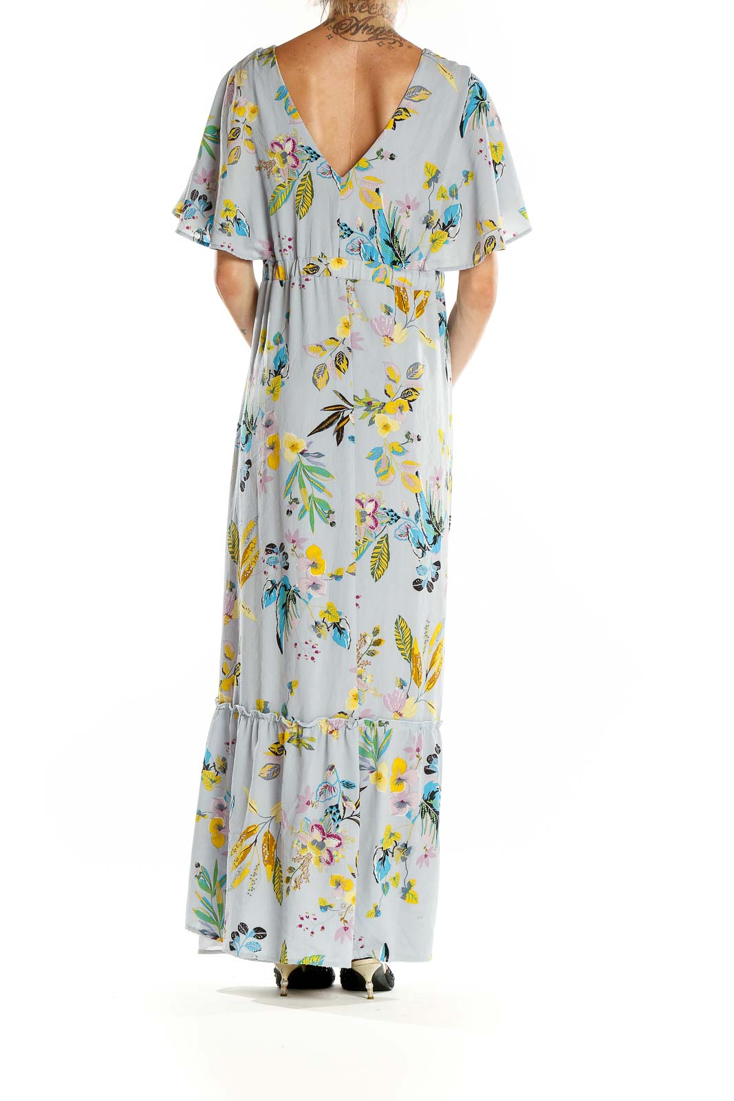 Back view of Slate & Willow light blue floral maxi wrap dress showing V-back and ruffle hem
