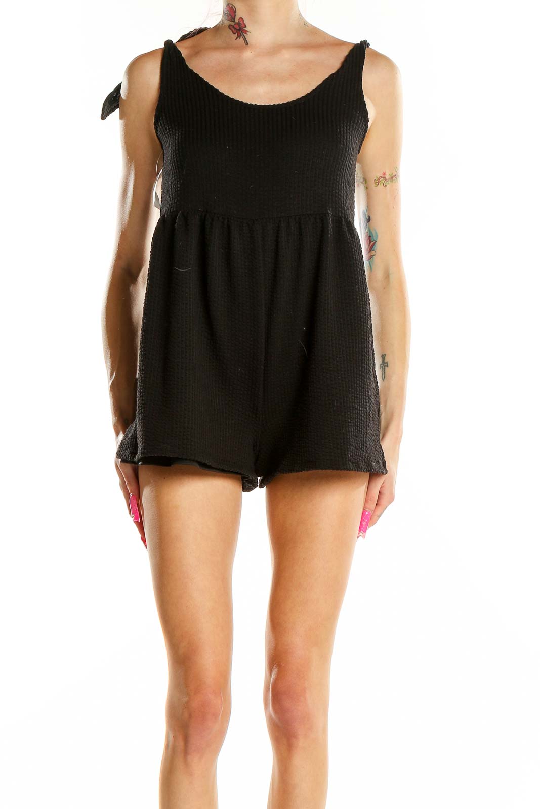 Front view of black textured sleeveless romper from Urban Outfitters
