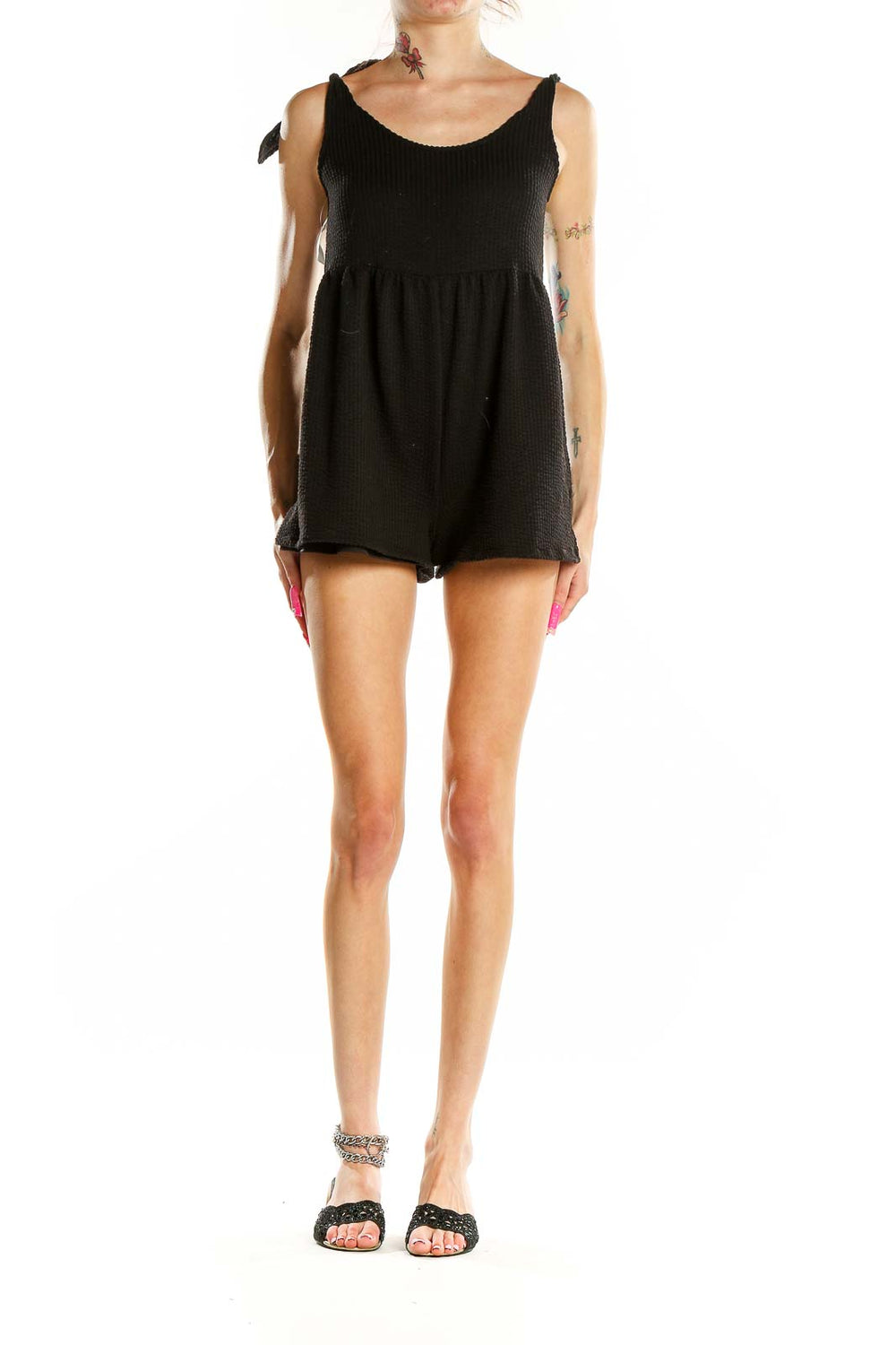 Front view of black textured sleeveless romper from Urban Outfitters